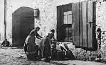 Women wash clothes outside of the Saracenhead Inn